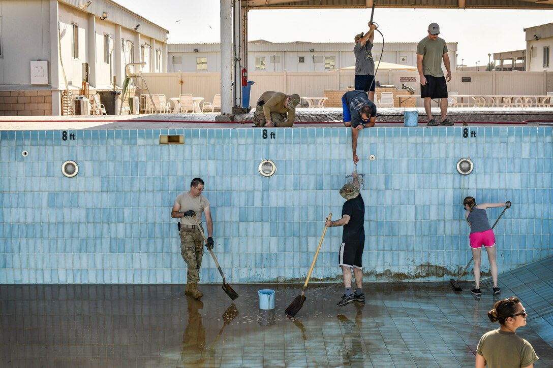 Airmen cleaning pools