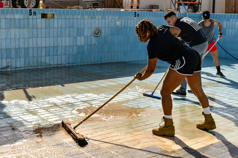 Airmen cleaning pools