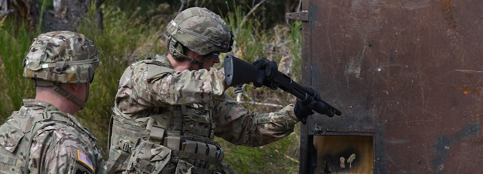 A Dutch Soldier uses an M500 shotgun to breach a door during the Urban Breach Training  at the Grafenwoehr Training Area, Germany, Aug. 29. 2018. U.S. Soldiers assigned to the 7th Army Combined Arms Training Center (CATC), 7th Army Training Command, instructed U.S. Soldiers assigned to various units across Europe, Latvian soldiers and Dutch soldiers on how to conduct urban breaching and offered new techniques for entering hostile or unknown buildings. (U.S. Army photo by Spc. Craig Carter)