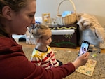 Danielle Frank, a military spouse, uses video conferencing technology to stay in contact with family during the COVID-19 quarantine, Gresham, Oregon, March 27, 2020. Staying connected while practicing social distancing is crucial to the mental well-being of Airmen and their families.