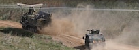 A high mobility multi-wheeled vehicle from the 101st Airborne Division (Air Assault) provides fire support for a Ukraine engineer vehicle during a water gap crossing demonstration as part of Rapid Trident 2019 in Yavoriv, Ukraine, Sept. 20, 2019. RT19 is an annual, multinational exercise occurring from Sept. 13-28, 2019, which involves approximately 3,700 personnel from 14 nations, that supports joint combined interoperability among partner militaries of Ukraine and the United States, as well as Partnership for Peace nations and NATO allies. (U.S. Army photo by Sgt. Kyle Larsen)