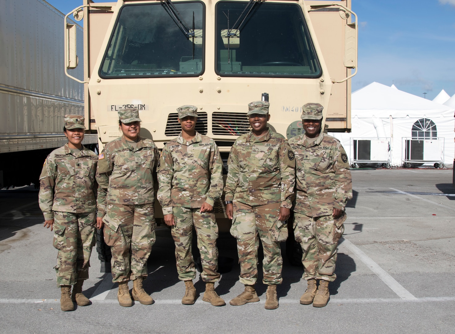Left to right, Spc. Francesca Chen-Shue, Pfc. Monica Nieves, Chief Warrant Officer Latania McCook, Pfc. Tyanna Harrison and Spc. Taquisha Hubbard, members of the all-female 356th Quartermaster (War Wagon) Company at a COVID-19 testing site in Miami Gardens, Florida.