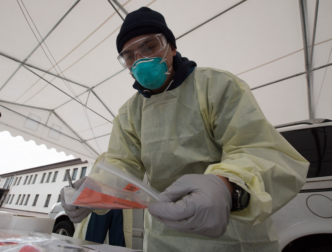 A picture of a medical technician handling medical supplies.