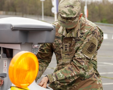 Lt. Gen. Daniel Hokanson, director of the Army National Guard, washes his hands while touring a COVID-19 screening site at FedEx Field in Landover, Md., March 31, 2020, with Army Secretary Ryan D. McCarthy, Maryland Adjutant General Maj. Timothy Gowen and Rep. Anthony G. Brown.