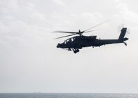 An AH-64 Apache helicopter, attached to U.S. Army Central Command (USARCENT) Task Force Sabre, operates with the guided-missile destroyer USS Paul Hamilton (DDG 60) during a joint naval and air integration operation, March 27, 2020. Paul Hamilton is deployed to the U.S. 5th Fleet area of operations in support of naval operations to ensure maritime stability and security in the Central Region, connecting the Mediterranean and Pacific through the Western Indian Ocean and three strategic choke points.