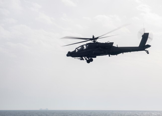 An AH-64 Apache helicopter, attached to U.S. Army Central Command (USARCENT) Task Force Sabre, operates with the guided-missile destroyer USS Paul Hamilton (DDG 60) during a joint naval and air integration operation, March 27, 2020. Paul Hamilton is deployed to the U.S. 5th Fleet area of operations in support of naval operations to ensure maritime stability and security in the Central Region, connecting the Mediterranean and Pacific through the Western Indian Ocean and three strategic choke points.
