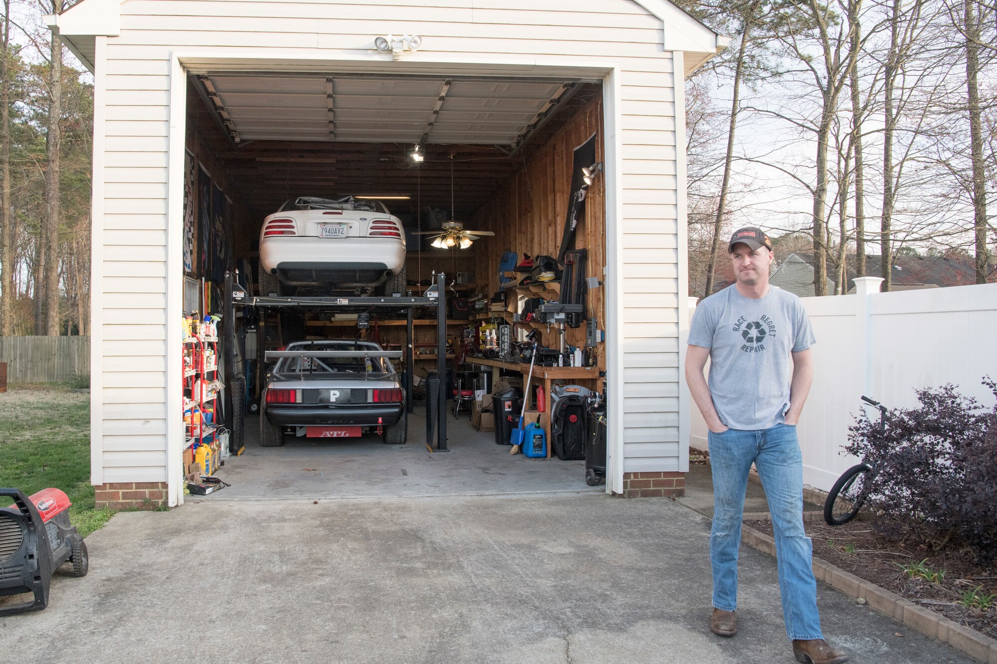 photo of a man in front of a garage