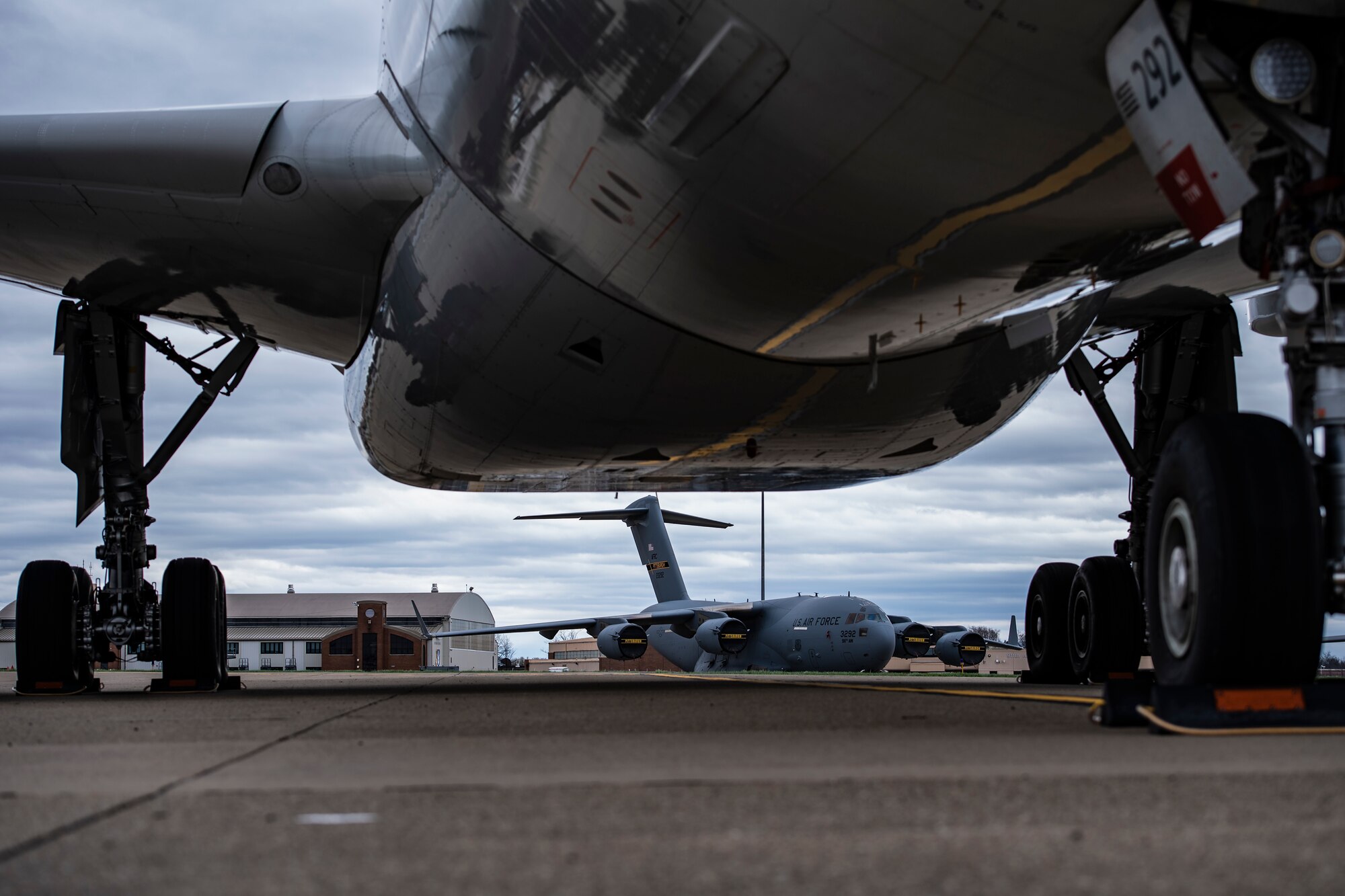 C-17 Globemaster III assigned to the 911th Airlift Wing sit on the flightline behind grounded commercial aircraft at the Pittsburgh International Airport Air Reserve Station, Pennsylvania, March 30, 2020.