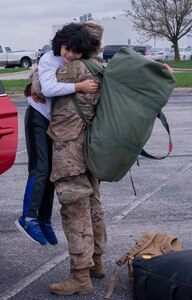 An Indiana National Guard Soldier with the 38th Infantry Division embraces her loved one in Indianapolis, March 31, 2020, after being deployed for nine months in the Middle East and spending two weeks in quarantine at Fort Hood, Texas. Despite having a non-traditional homecoming to adhere to social distancing standards Soldiers were still able to greet their families.