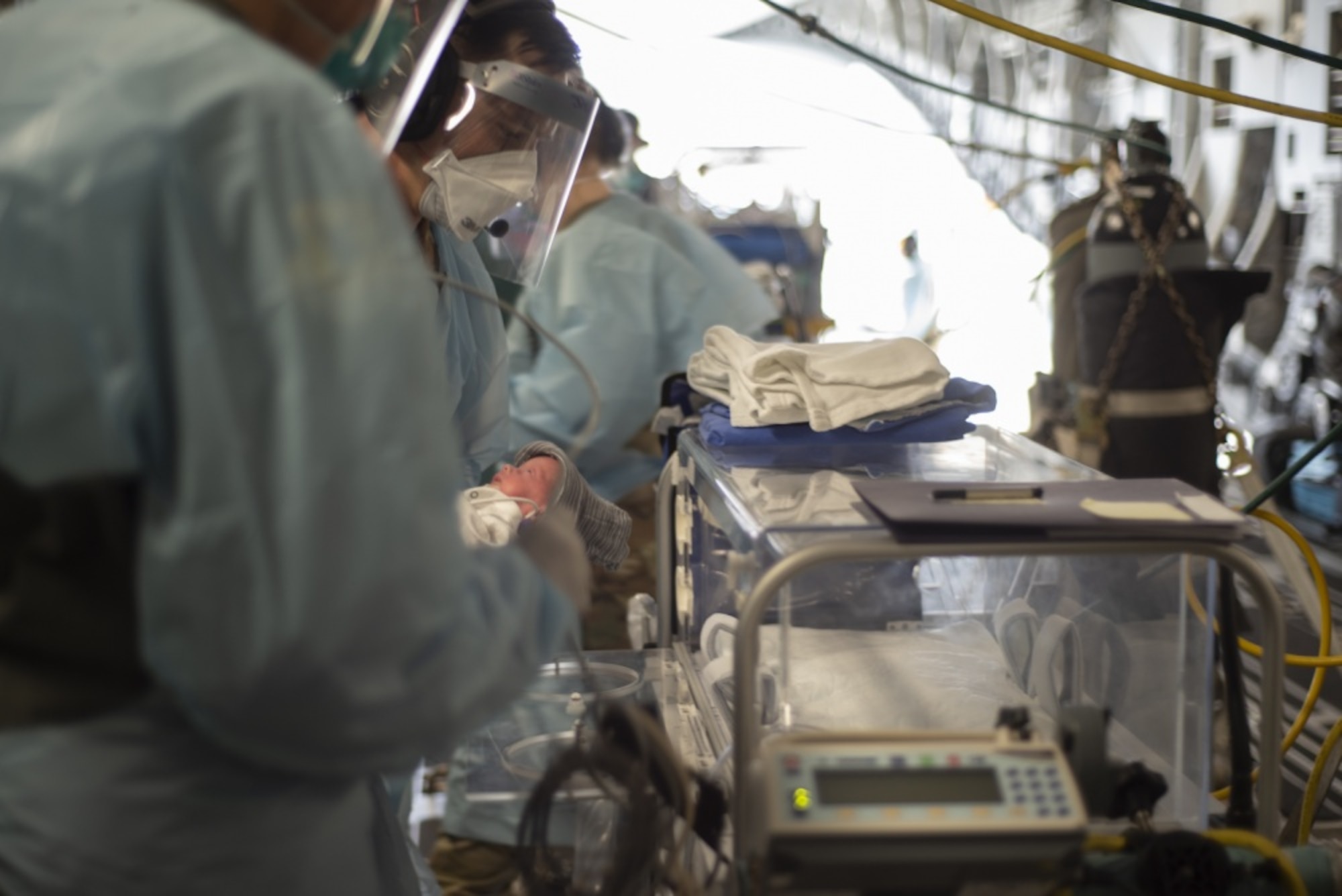 Pacific Air Force’s Airmen and Soldiers transload newborn twins onto a C-17 Globemaster III
 during an aeromedical evacuation mission, March 30, 2020, at Osan Air Base, Republic of Korea.