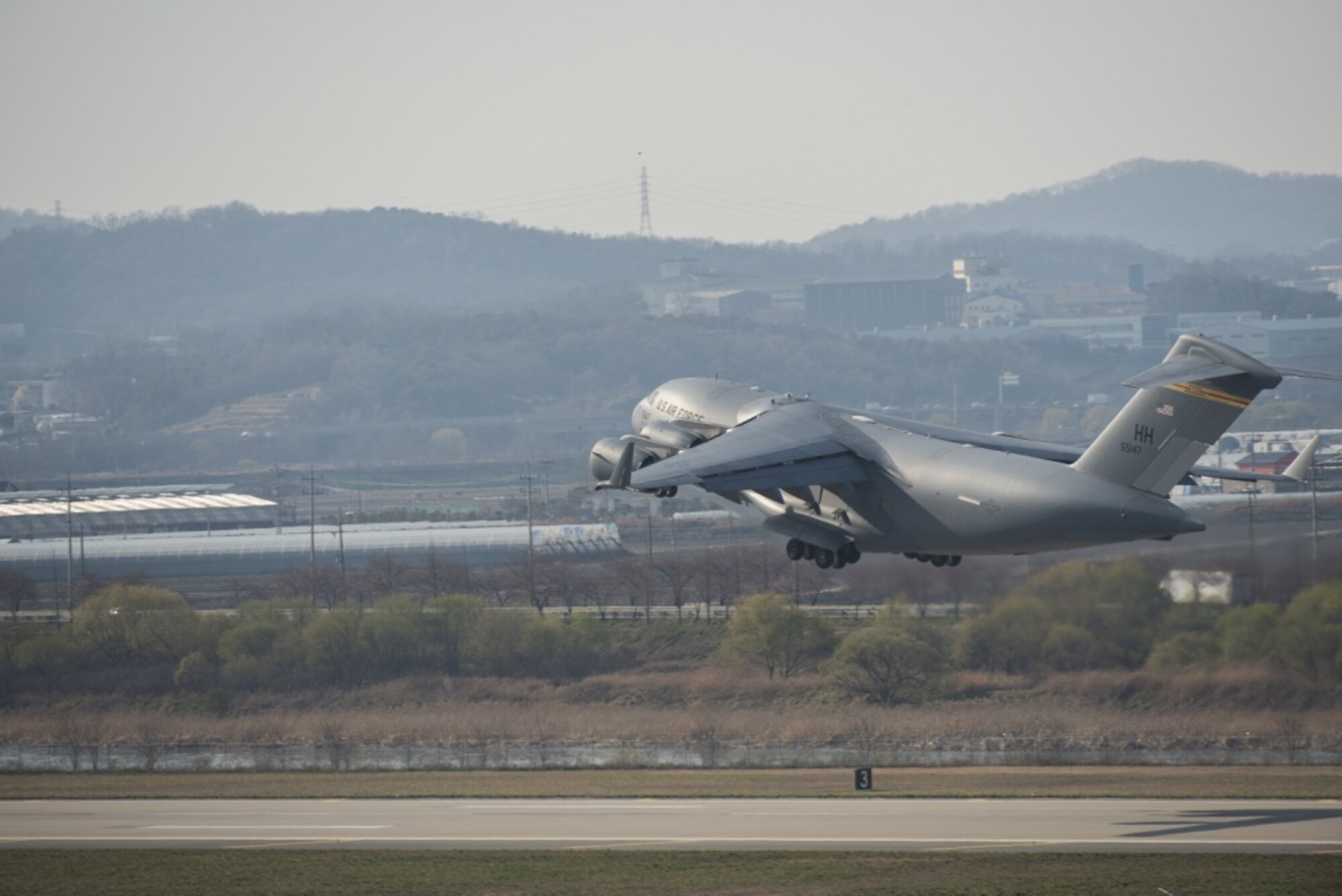 A U.S. Air Force C-17 Globemaster III takes off from Osan Air Base, March 30, 2020. The C-17 is carrying twin newborns that are being evacuated to Walter Reed National Military Medical Center. (U.S. Air Force photo by Staff Sgt. James L. Miller)