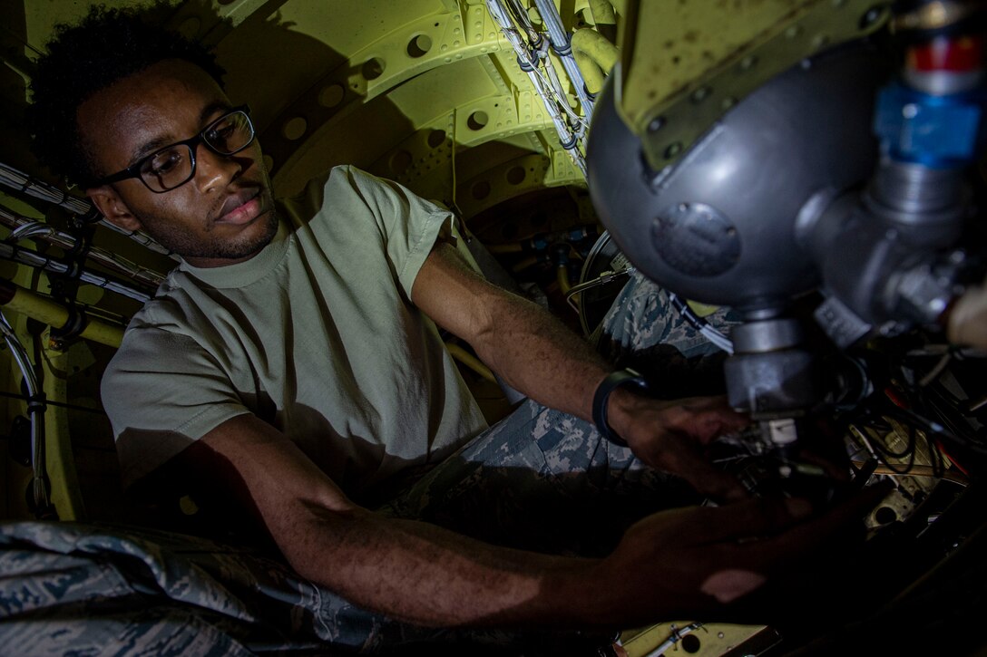 Photo of an Airman performing maintenance on an A-10C Thunderbolt II fire bottle.