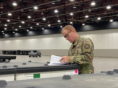 Members of the Michigan National Guard assist the Federal Emergency Management Agency with logistics support to establish a federal medical station at Detroit’s TCF Center, March 31, 2020. The site can be used for patients if hospitals become overwhelmed with COVID-19 patients.