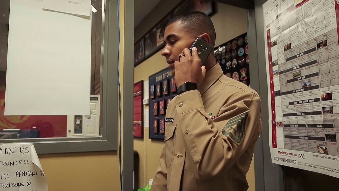 Marine Staff Sgt. Dimitri Armstead makes telephone calls while prospecting from the office, Nov. 21.