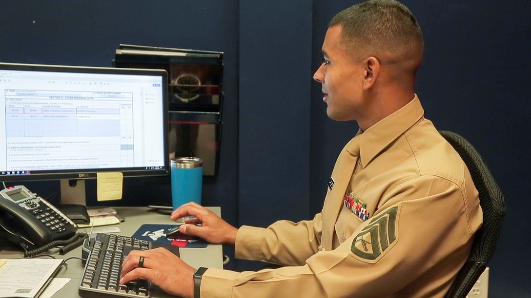 Marine Staff Sgt. Dimitri Armstead works on his computer while prospecting from the office, Nov. 21.