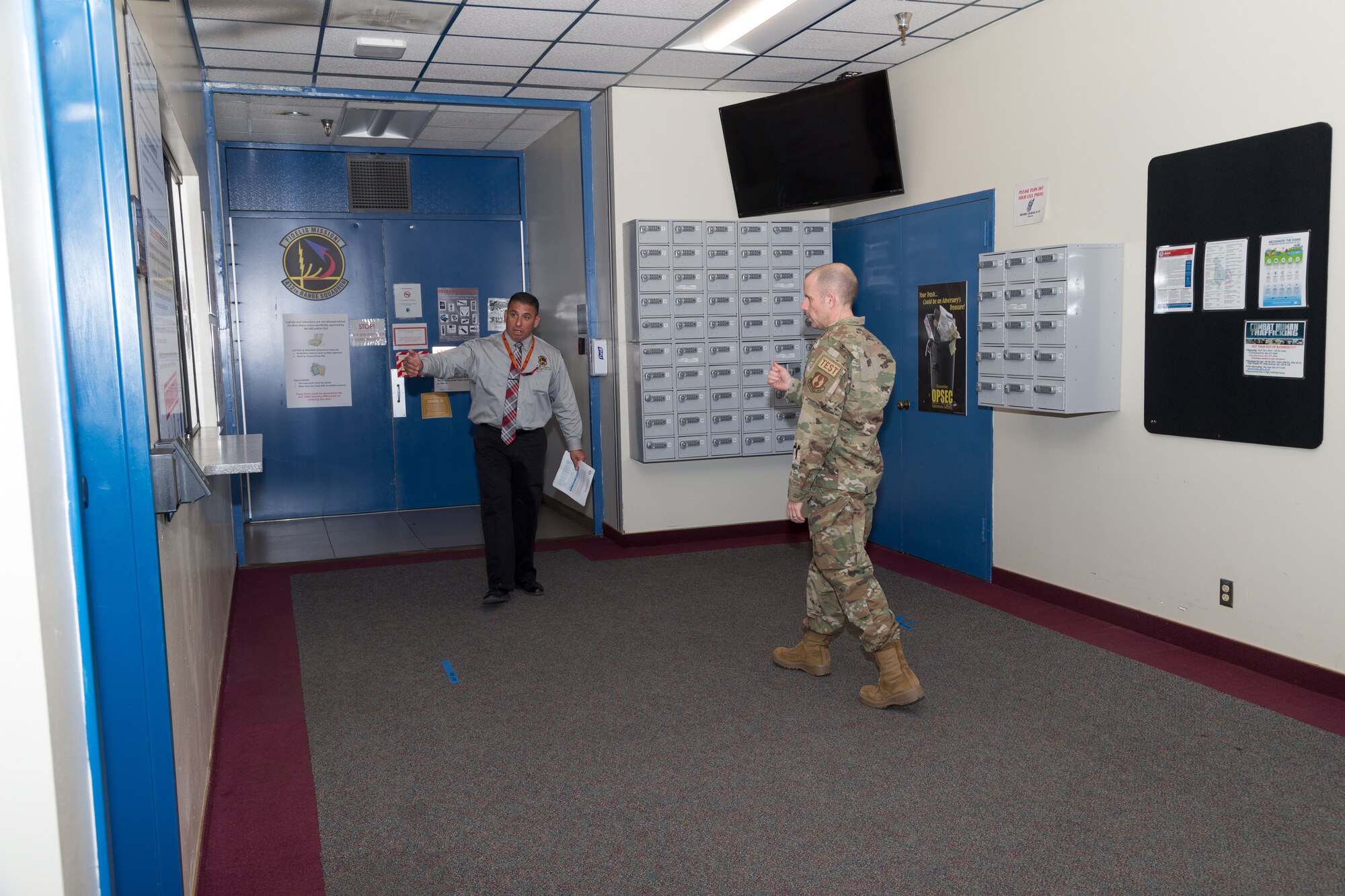 Col. Matthew Higer, 412th Test Wing Commander, tours the Ridley Mission Control Center on Edwards Air Force Base, California, March 31. Higer toured the facility to see the expanded sanitation procedures recently put in place to help stem the coronavirus COVID-19 outbreak. (Air Force photo by Ethan Wagner)