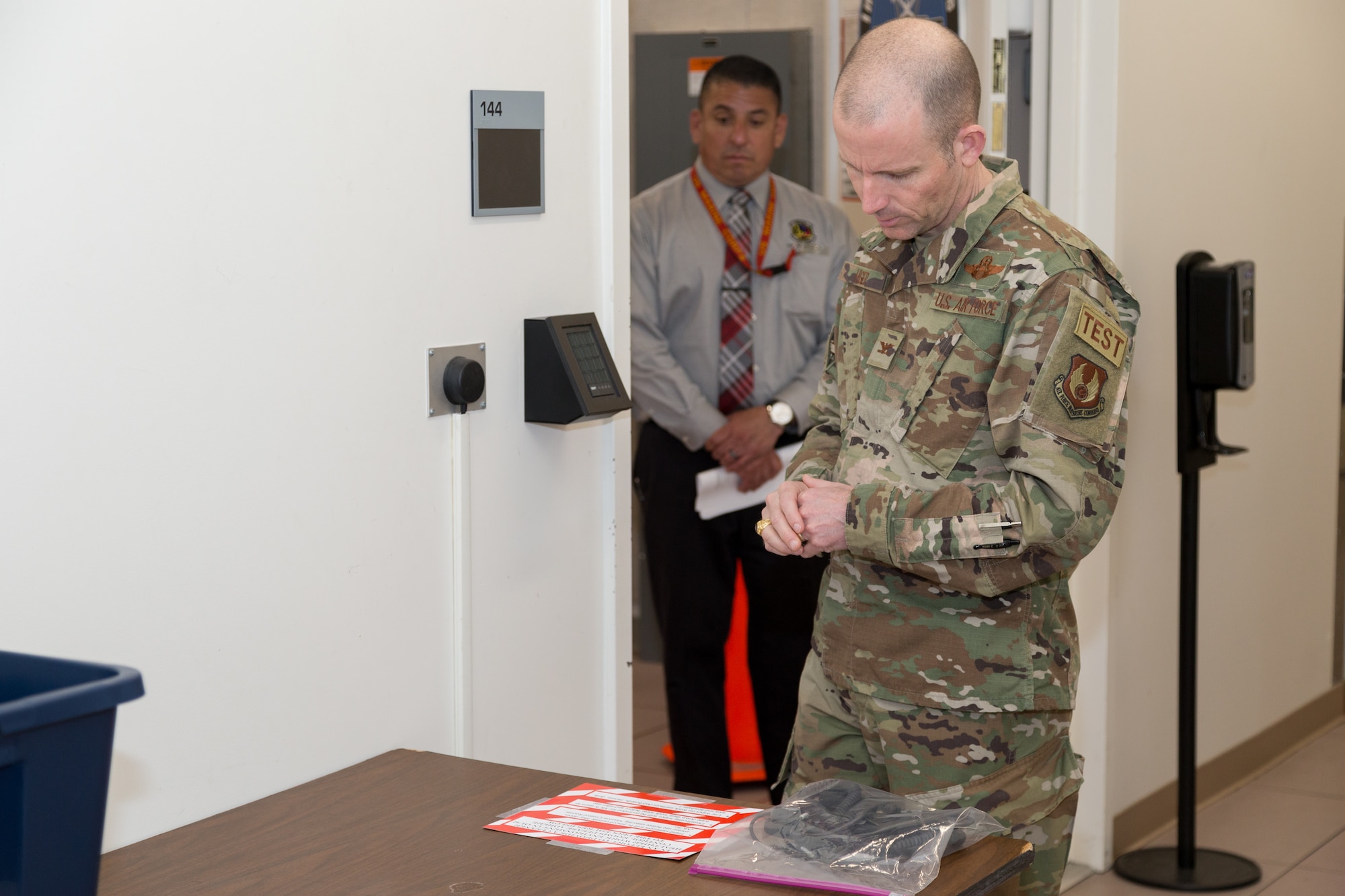 Col. Matthew Higer, 412th Test Wing Commander, reads over expanded sanitation procedures at the Ridley Mission Control Center on Edwards Air Force Base, California, March 31. (Air Force photo by Ethan Wagner)