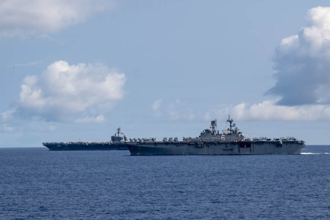 Two Navy ships sail in the Philippine Sea.