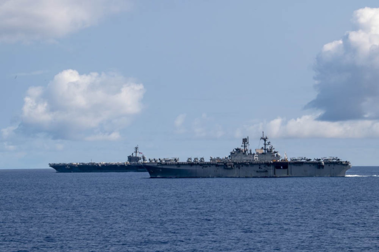 Two Navy ships sail in the Philippine Sea.