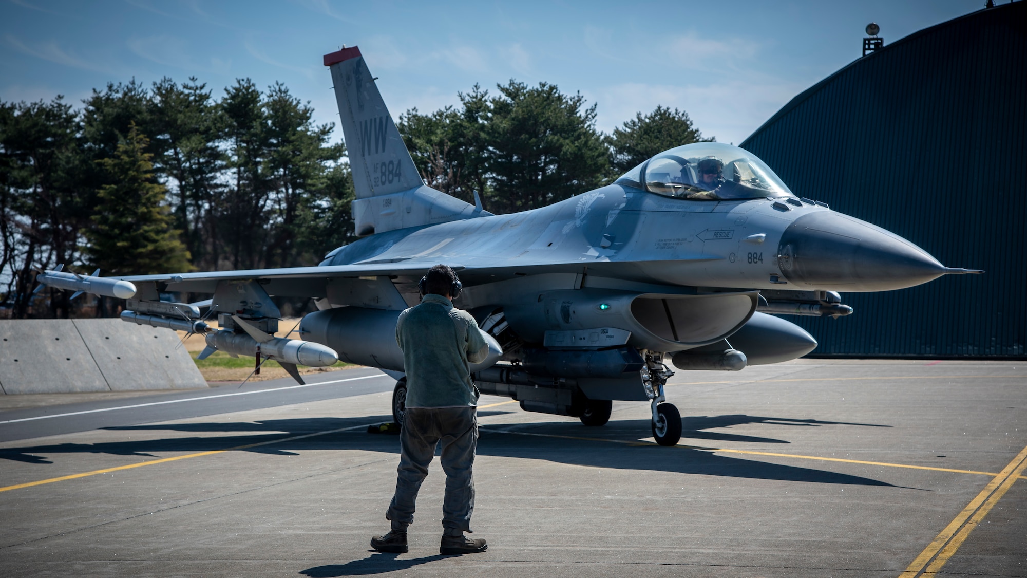 U.S. Air Force Airman 1st Class Juan Humenez, a unit tactical aircraft maintainer, marshals an F-16 Fighting Falcon at Misawa Air Base, Japan, March 30, 2020. Tactical aircraft maintenance specialists ensure every component of the aircraft is maintained to the standards. They ensure the aircraft are ready to fly at a moment’s notice so pilots can safely and effectively complete their mission. Even amidst current policy restrictions due to COVID-19, the 35th Fighter Wing’s mission of projecting combat air power and defending the U.S. and Japan is still moving forward. (U.S. Air Force photo by Airman 1st Class China M. Shock)