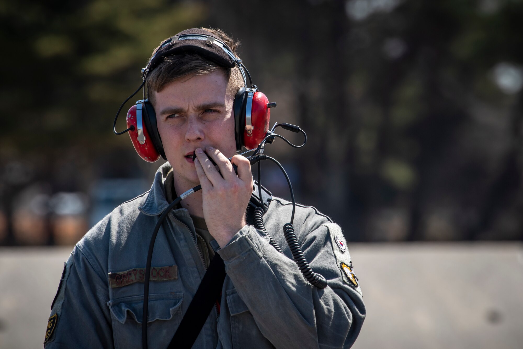 U.S. Air Force Senior Airman Kyle Greyshock, a 13th Fighter Squadron avionics systems journeyman, speaks into a radio headset at Misawa Air Base, Japan, March 30, 2020. Avionics specialists require attention to detail since proper maintenance can mean the difference between mission success and failure. Part of their job consists of helping make quick fixes to jets to ensure they are available for flight. (U.S. Air Force photo by Airman 1st Class China M. Shock)