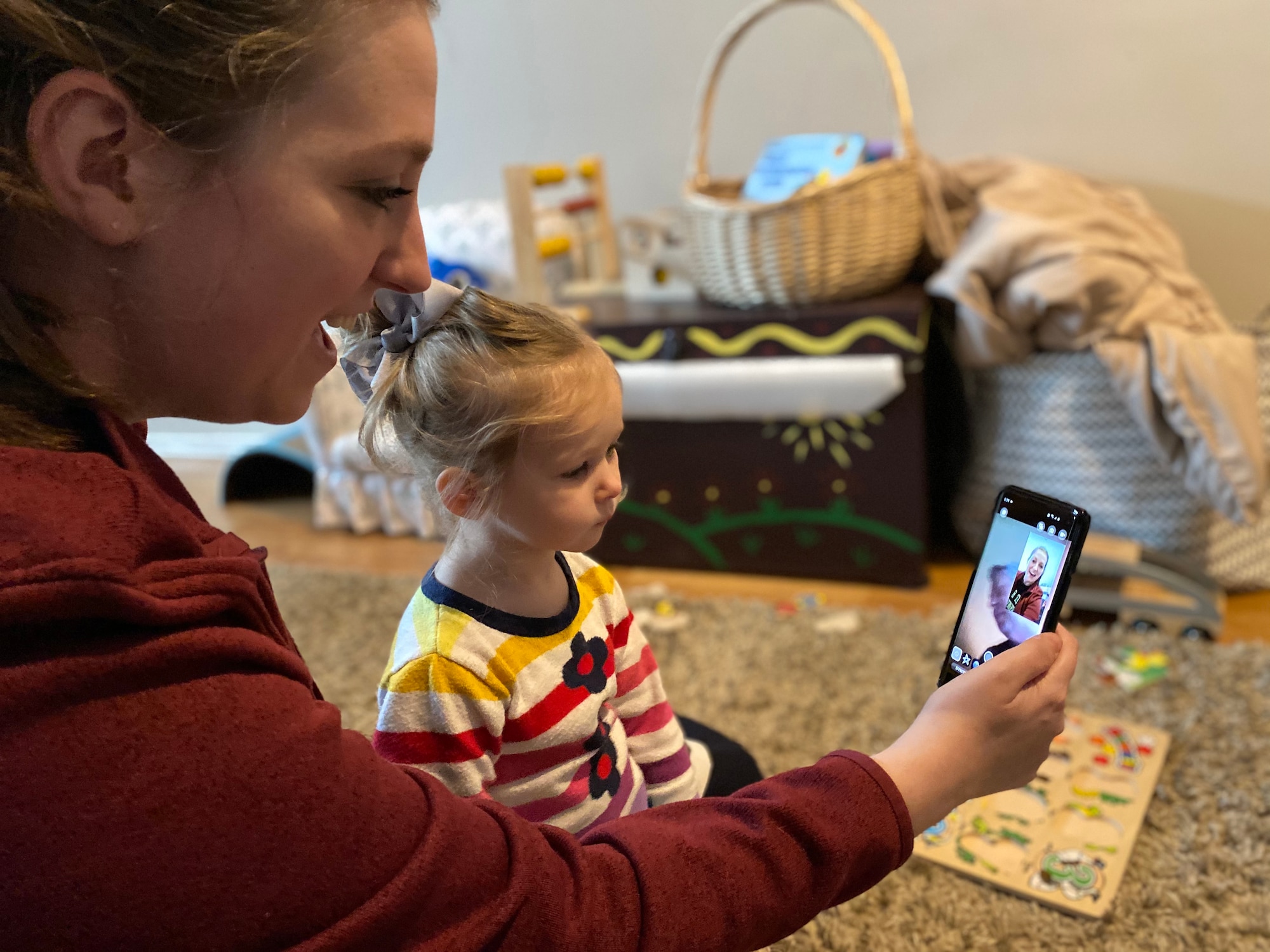 Danielle Frank, a military spouse, uses video conferencing technology to stay in contact with family during the COVID-19 quarantine, Gresham, Oregon, March 27, 2020. Staying connected while practicing social distancing is crucial to the mental well-being of Airmen and their families.