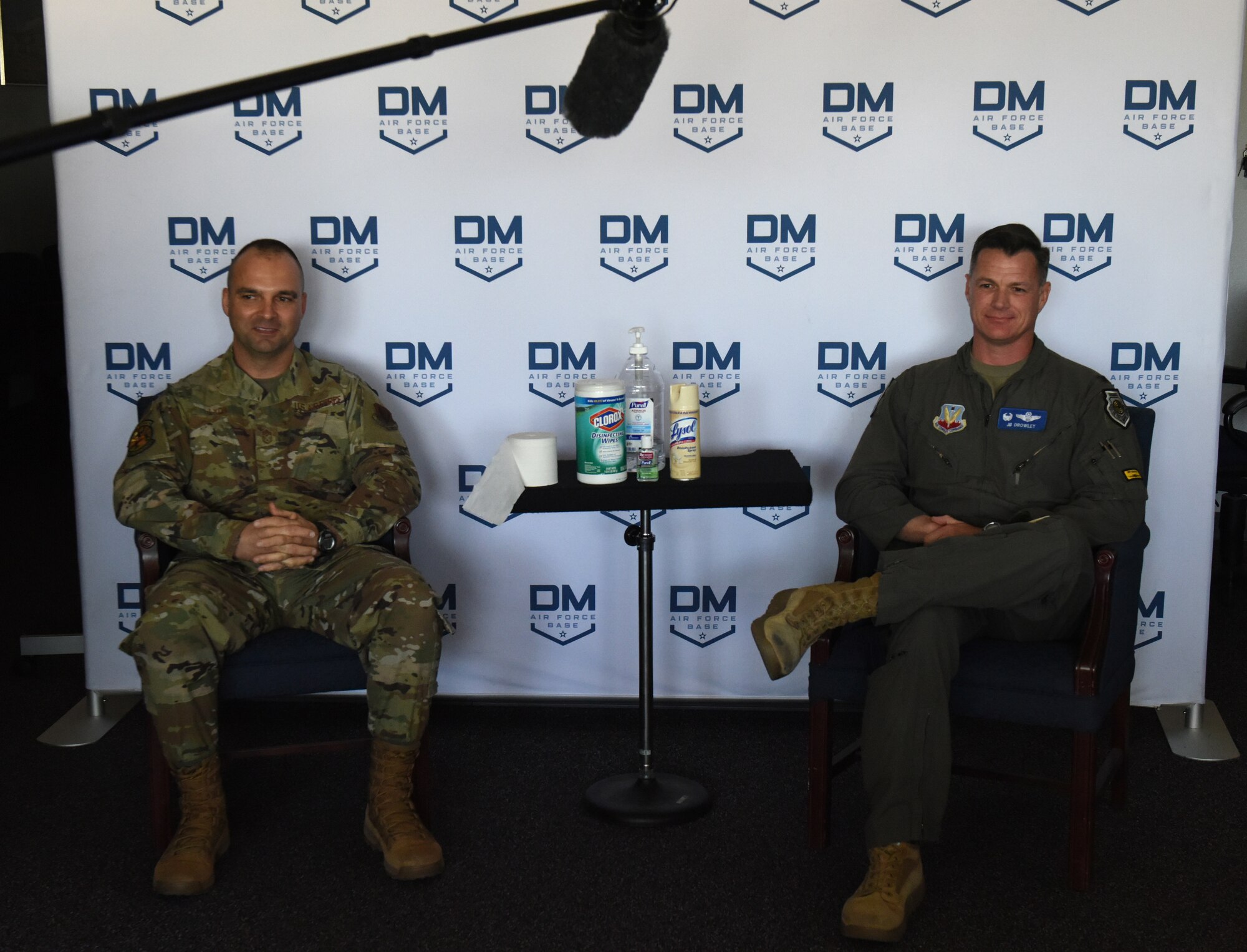 A photo of Davis-Monthan Air Force Base leadership sitting and getting ready for a live-stream broadcast in an office