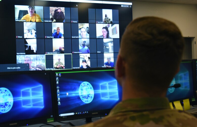 A photo of a computer screen with Air Force members video chatting
