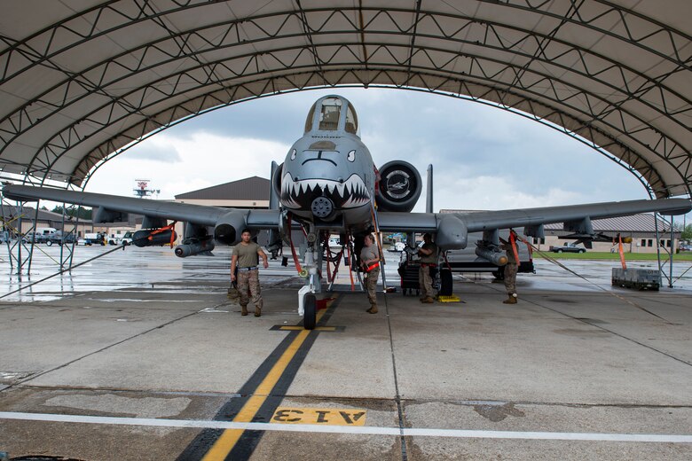Photo of Airmen inspecting an A-10C Thunderbolt II.