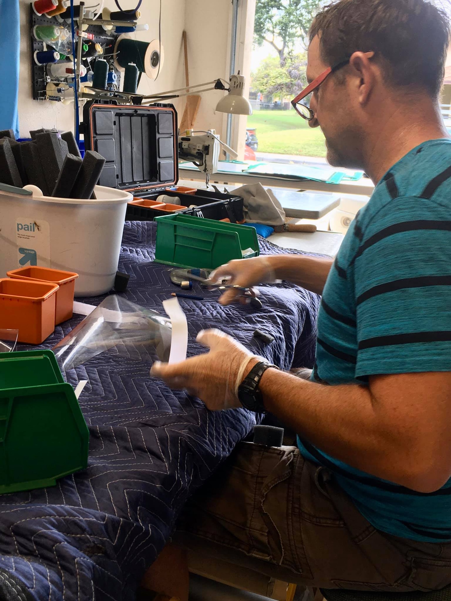 U.S. Coast Guard Chief Petty Officer Bob McCormick, U.S. Coast Guard Cutter Joseph Gerczak operations chief, creates face shields for medical professionals in Hawaii, while practicing social distancing. According to the Center for Disease Control, face shields help prevent large-particle droplets, splashes, sprays or splatter that may contain germs from reaching the mouth and nose of the person wearing the shield. (Courtesy photo)