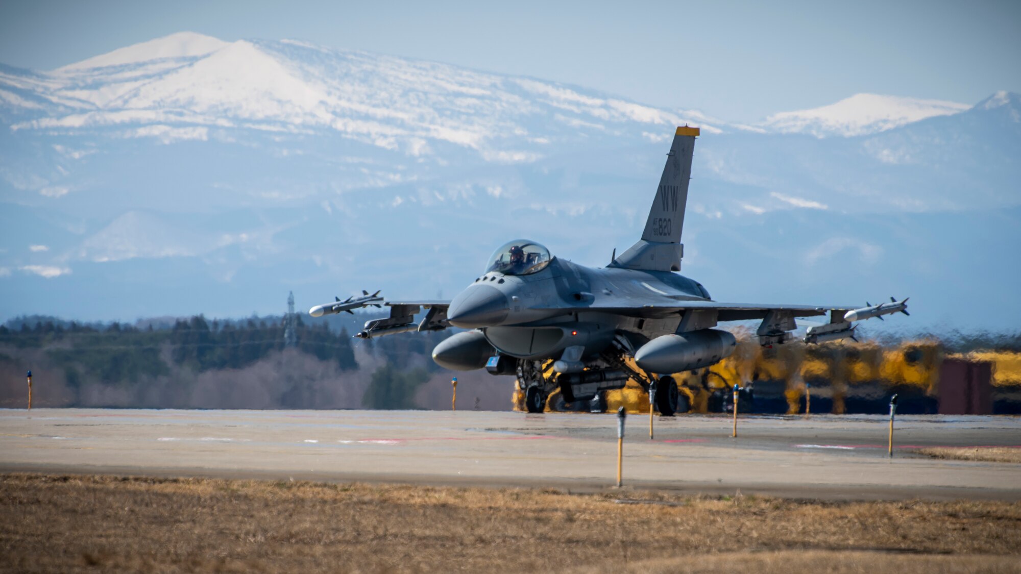 A U.S. Air Force F-16 Fighting Falcon taxis down the runway at Misawa Air Base, Japan, March 30, 2020. In an air-to-surface role, the F-16 can fly more than 500 miles, deliver its weapons with superior accuracy, defend itself against enemy aircraft, and return to its starting point. This F-16 belongs to the 14th Fighter Squadron, assigned to Misawa AB in 1994. Their emblem is the Fighting Samurai. (U.S. Air Force photo by Airman 1st Class China M. Shock)