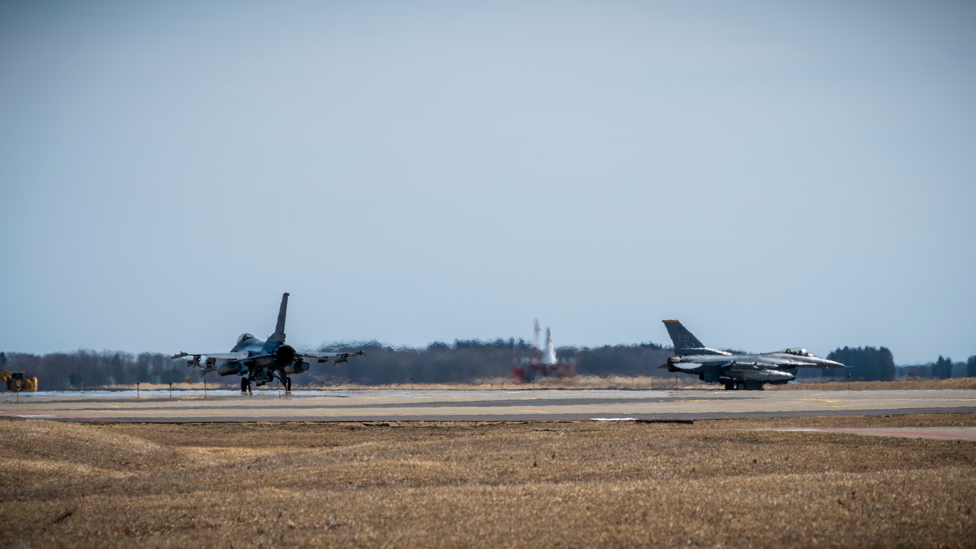 Two U.S. Air Force F-16 Fighting Falcons taxi down the runway at Misawa Air Base, Japan, March 30, 2020. During Operation Allied Force, U.S. Air Force F-16 Fighting Falcon fighters flew a variety of missions, including the suppression of enemy air defense, offensive counter air, defensive counter air, close air support and forward air controller missions. (U.S. Air Force photo by Airman 1st Class China M. Shock)