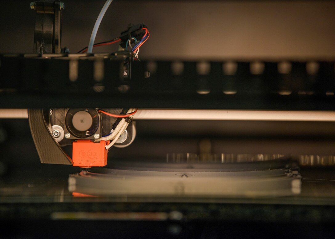 A 3D printer produces a face mask.