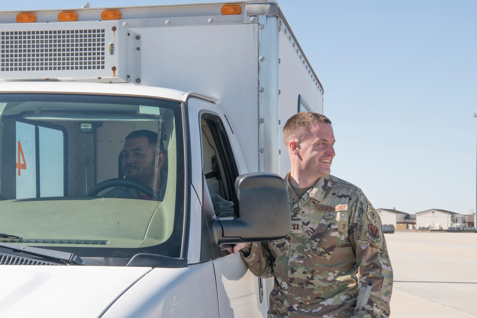 photo of a maintenance Airman near a truck