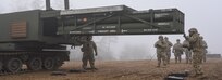 U.S. Soldiers, assigned to 1st Battalion, 6th Field Artillery Regiment, 41st Field Artillery Brigade, load M270A1 Multiple Launch Rocket System (MLRS) rocket pod containers during a live-fire exercise at 7th Army Training Command's Grafenwoehr Training Area, Grafenwoehr, Germany, Jan. 27, 2020.