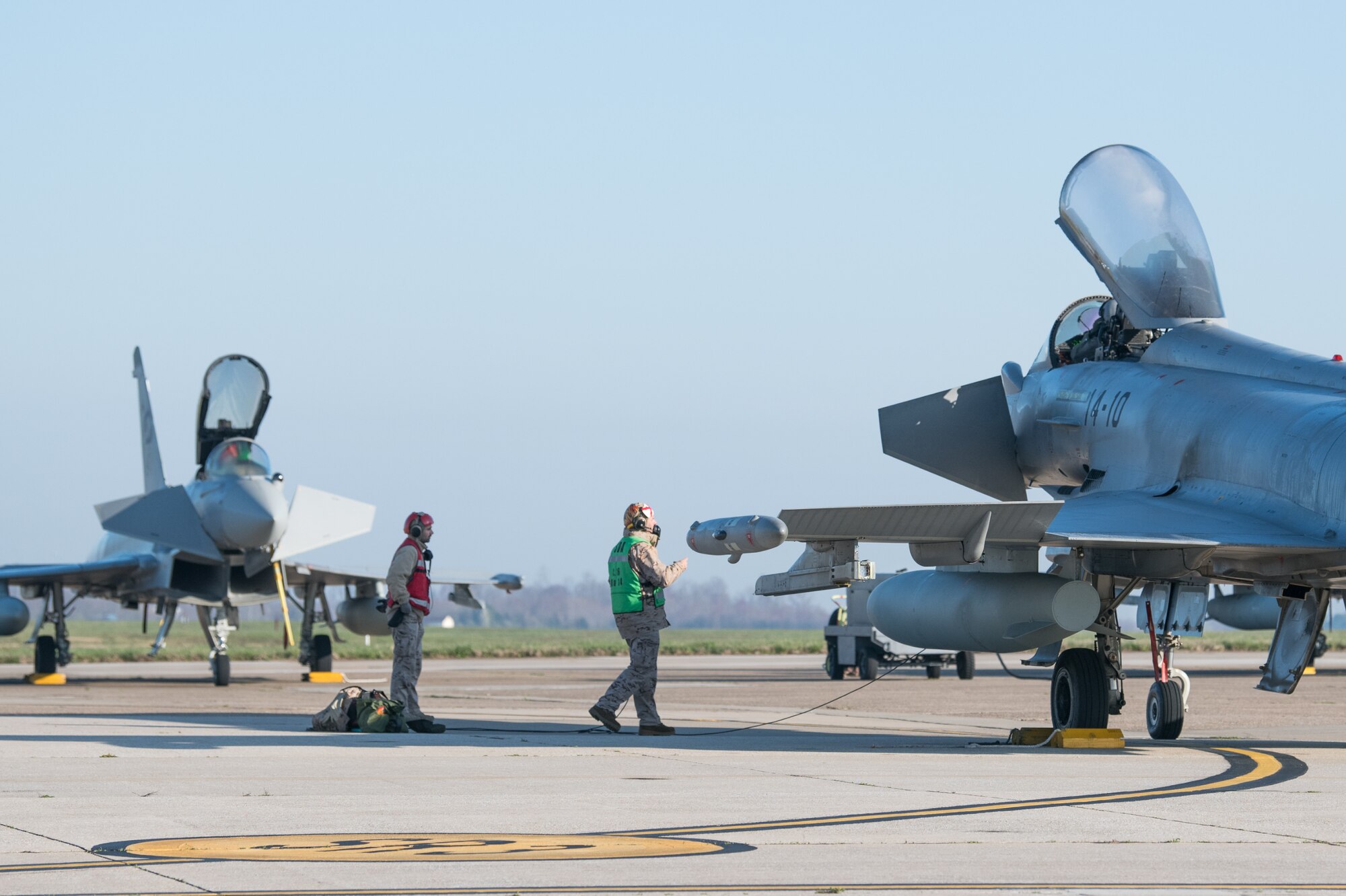 Spanish Airmen prepare Eurofighter Typhoons for take-off, March 26, 2020, at Dover Air Force Base, Delaware. The U.S Air Force and it’s Air Mobility Command welcome the opportunity to support our international partners and Allies as they respond to impacts of the COVID-19 pandemic. Dover Air Force Base hosted more than a dozen aircraft as they return to their home countries following the cancellation of Exercise Red Flag at Nellis AFB, Nevada. Through intense internal coordination and in collaboration with interagency partners, all of the affected aircraft have been approved to redeploy to their host nations. Dover continues to prioritize the safety of our service members and community as we support the safe return of our NATO partners. (U.S. Air Force photo by Mauricio Campino)