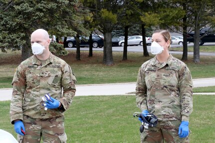 Sgt. Jebediah Jenkins and Pfc. Jenna Zinser, Wisconsin National Guard health care specialists, prepare to evaluate people at the Saint Francis de Sales Seminary in St. Francis, Wis. Guard troops helped set up rooms in the building, which serves as an isolation facility for Milwaukee County’s homeless during the COVID-19 pandemic.