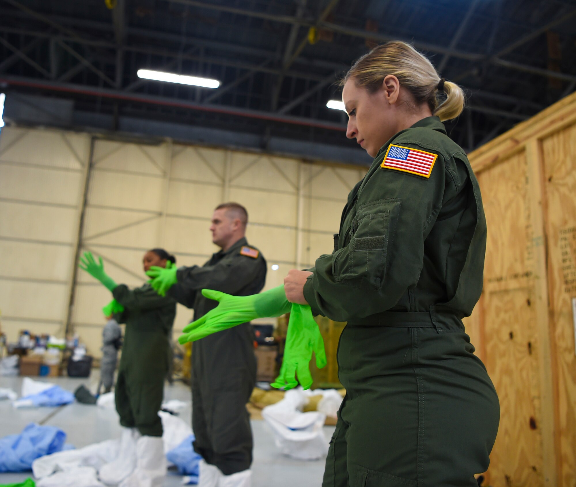 U.S. Air Force Staff Sgt. Laura Mendoza dons her personal protection equipment March 5, 2019, during transportation isolation system training at Joint Base Charleston, S.C. Mendoza is a respiratory therapist from the 60th Surgical Operations Squadron at Travis Air Force Base, Calif. Engineered and implemented after the Ebola virus outbreak in 2014, the TIS is an enclosure the Department of Defense can use to safely transport patients with highly contagious diseases. (U.S. Air Force photo by Senior Airman Cody R. Miller)