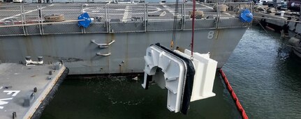 Hub changeout cofferdam being lowered into the water