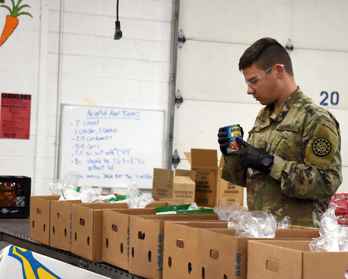 Michigan Army National Guard Soldiers assist the Feeding America West Michigan food bank, which feeds people in 40 of 83 Michigan counties but was struggling to operate because its volunteers were sent home to protect them from the COVID-19 pandemic, Comstock Park, Michigan, March 31, 2020.