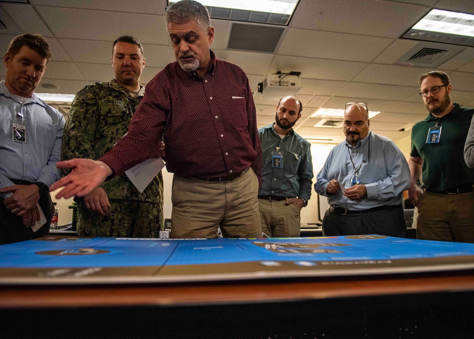 200115-N-LW865-0017 (Jan. 15, 2020) NEWPORT, R.I. Members of various commands and U.S. government agencies participate in the annual War-Gaming Fundamentals course held at the U.S. Naval War College Jan. 15. The five-day course is held to teach the war-gaming skills that NWC uses to help decision-makers shape the future Navy. Naval Surface Warfare Center, Philadelphia Division (NSWCPD) engineers Chris Wildmann (third from right), John Kusiean (second from right), and John Berardino (far right) graduated from the course and lead the Command’s efforts. (U.S. Navy photo by Mass Communication Specialist 2nd Class Tyler D. John/released)