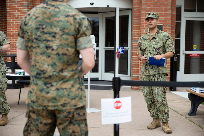 A sailor speaks to other service members.