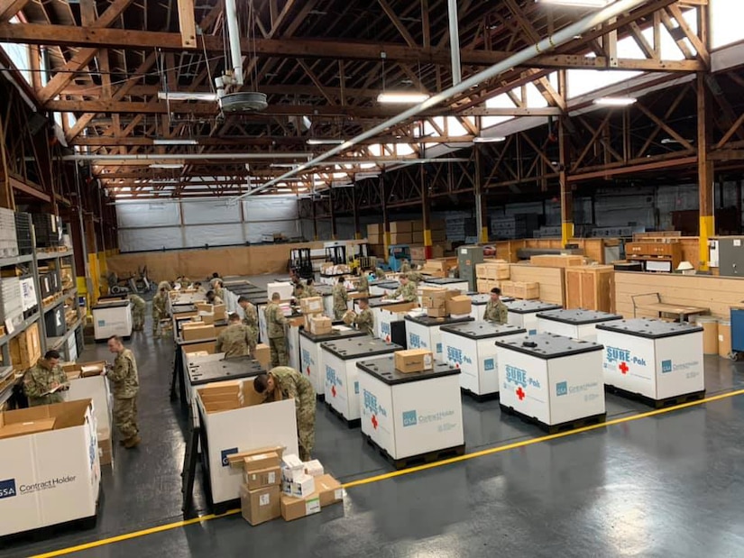 Soldiers from the 551st Medical Company (Logistics) and the 627th Hospital Center unload tri-walls of medical supplies as they arrive at Joint Base Lewis McChord, Washington, in support of COVID-19 relief efforts.
