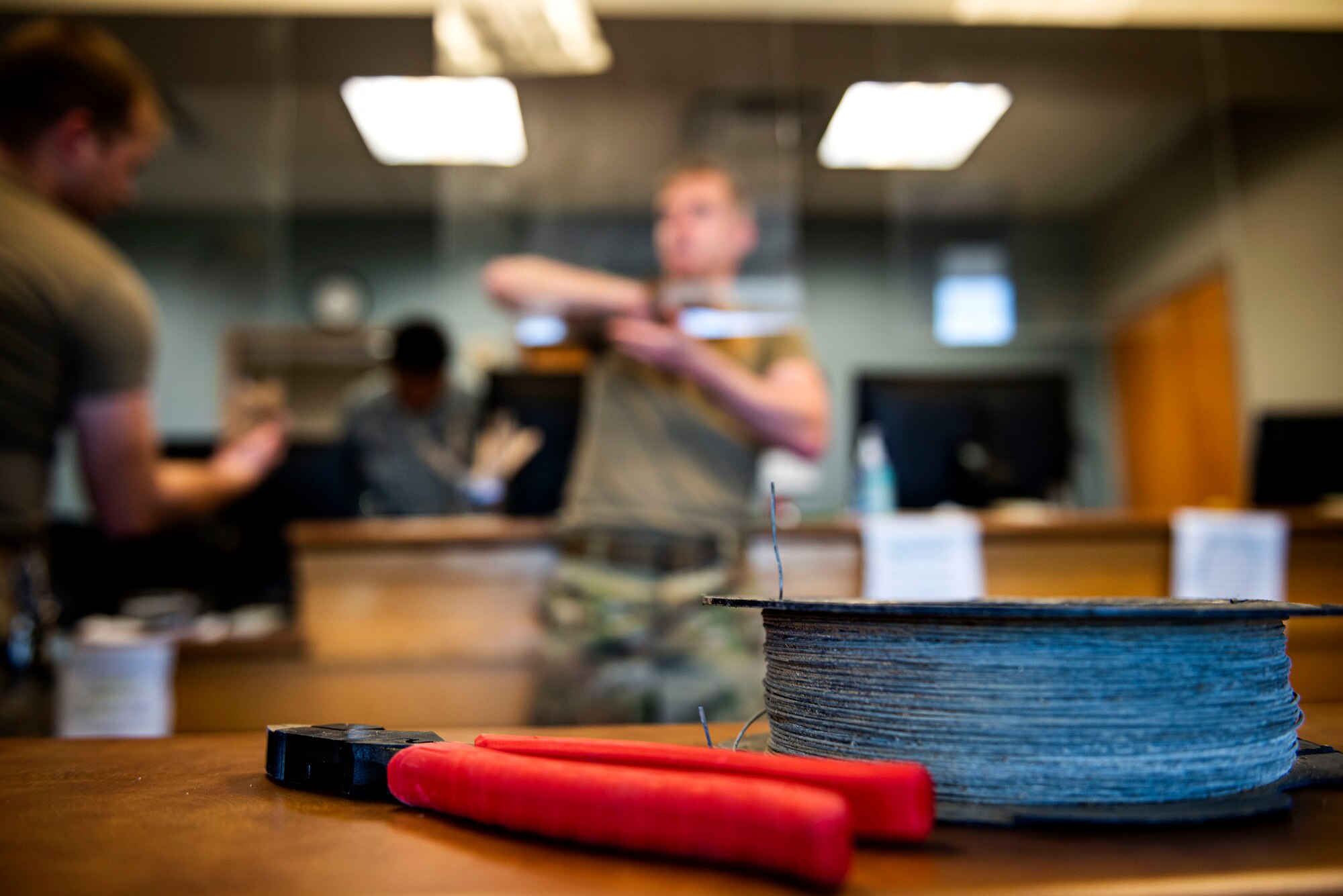 Photo of Airmen cleaning plexiglass barriers.