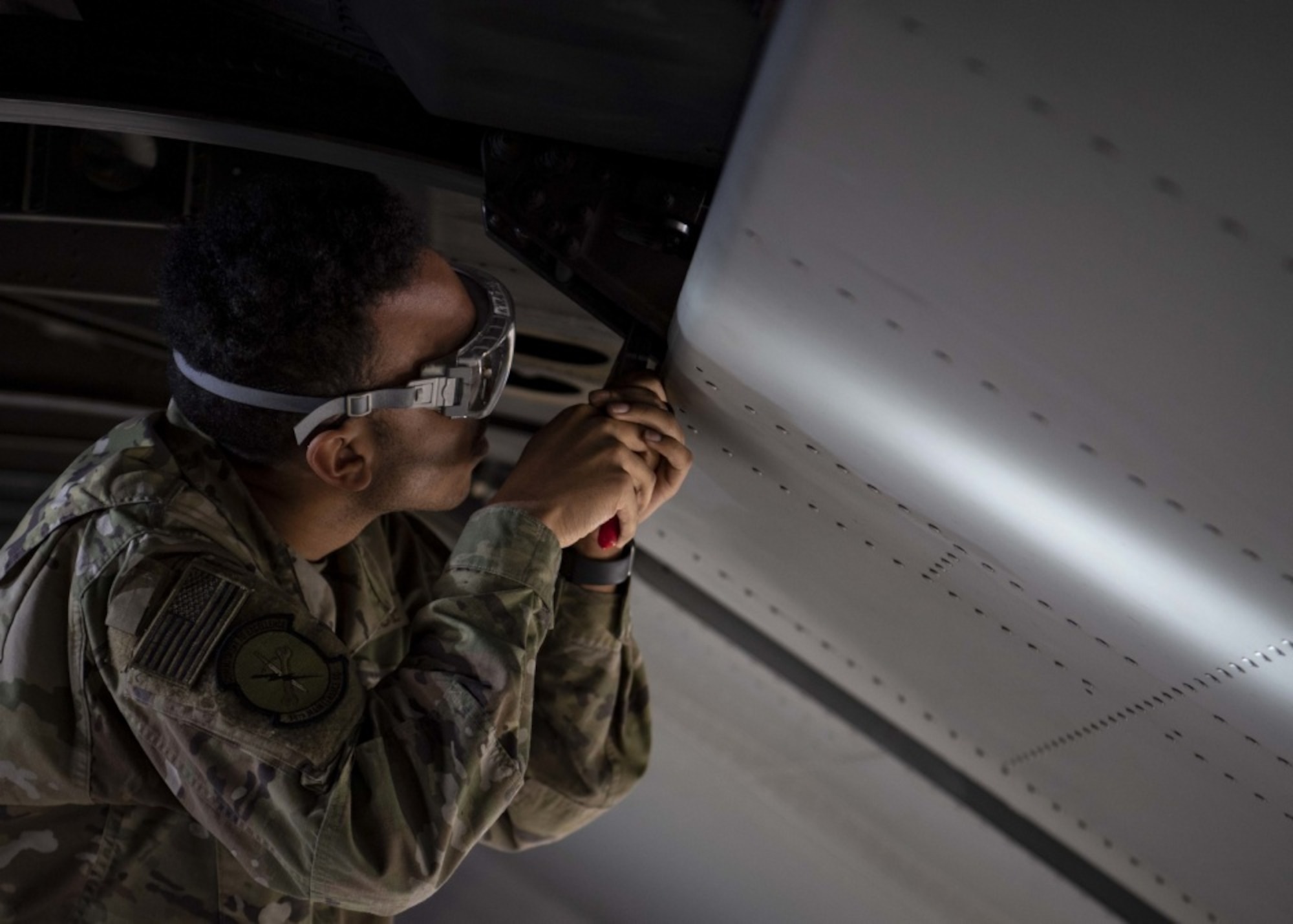 An Airmen works on an aircraft