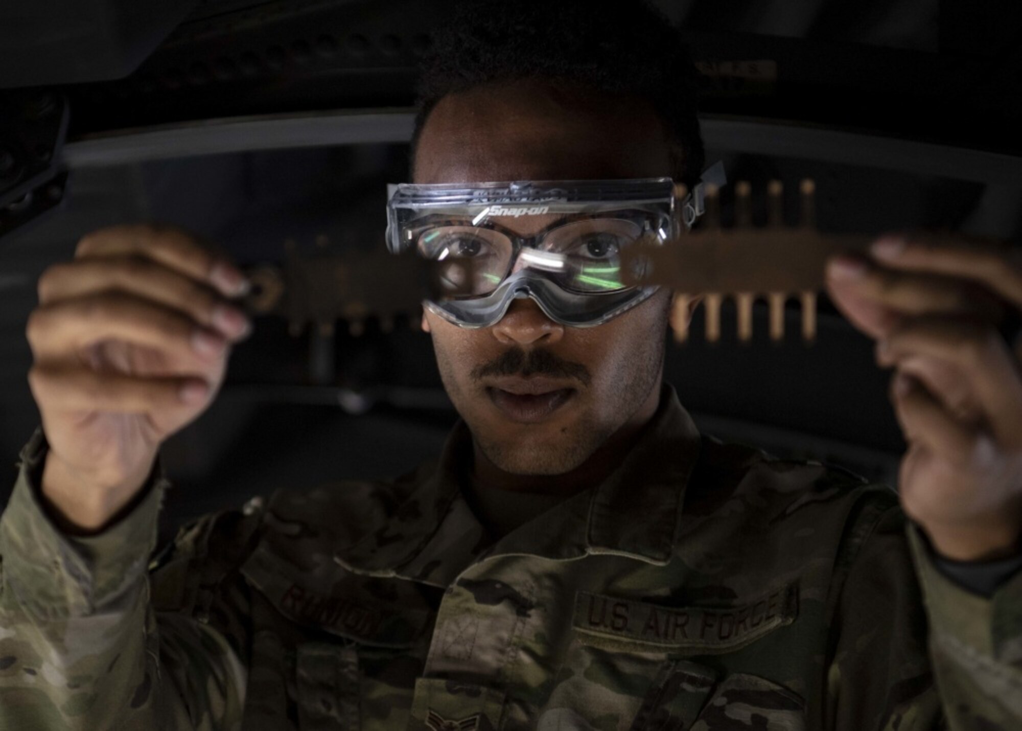 An Airmen works on an aircraft