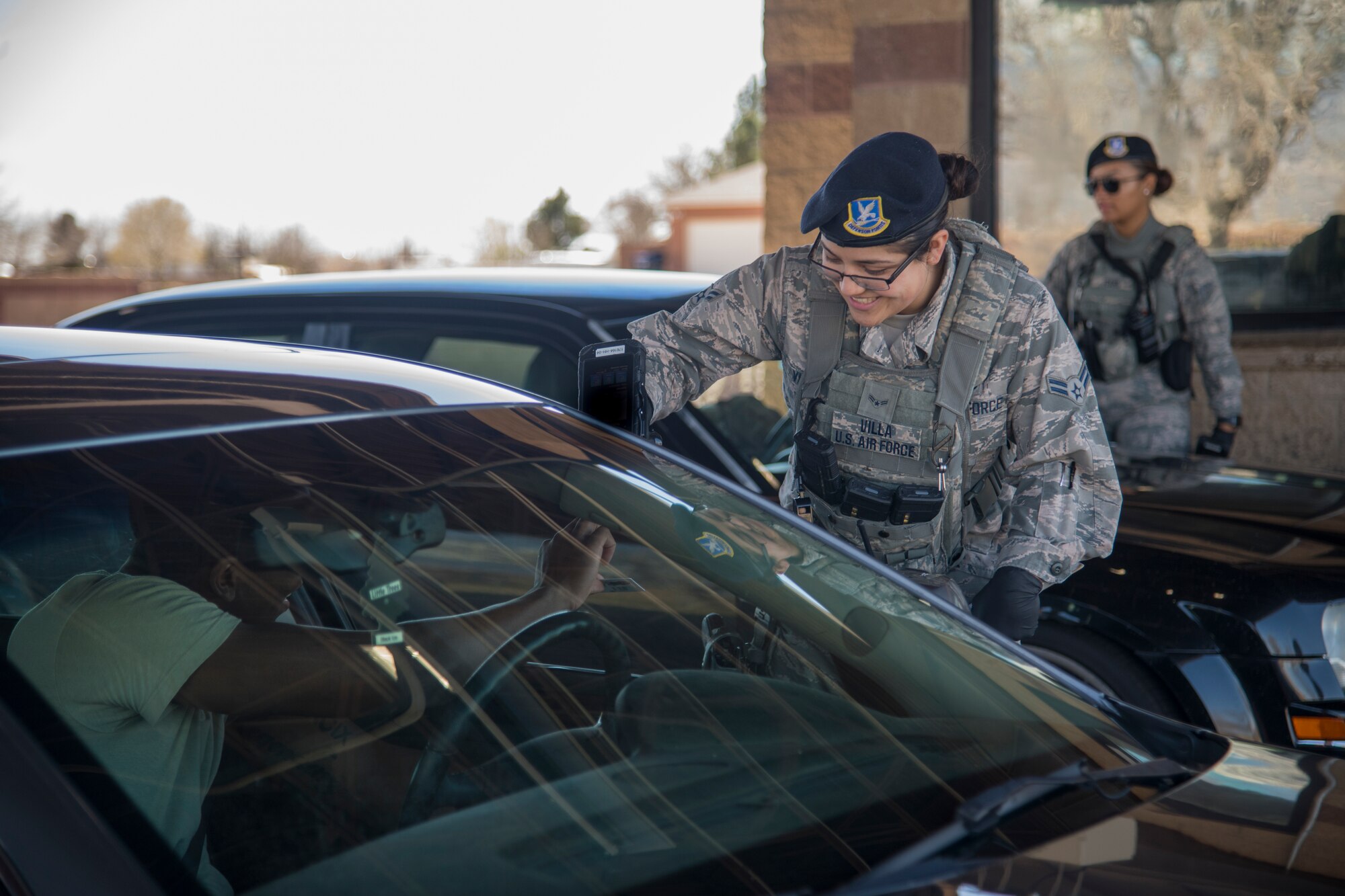 Airman 1st Class Chelsea Villa, 49th Security Force Squadron installation entry controller, scans an ID at the main gate of Holloman Air Force Base, N.M., March 20, 2020. Security forces members are following additional procedures and protocols in an effort to prevent the spread of COVID-19. (U.S. Air Force photo by Senior Airman Collette Brooks)