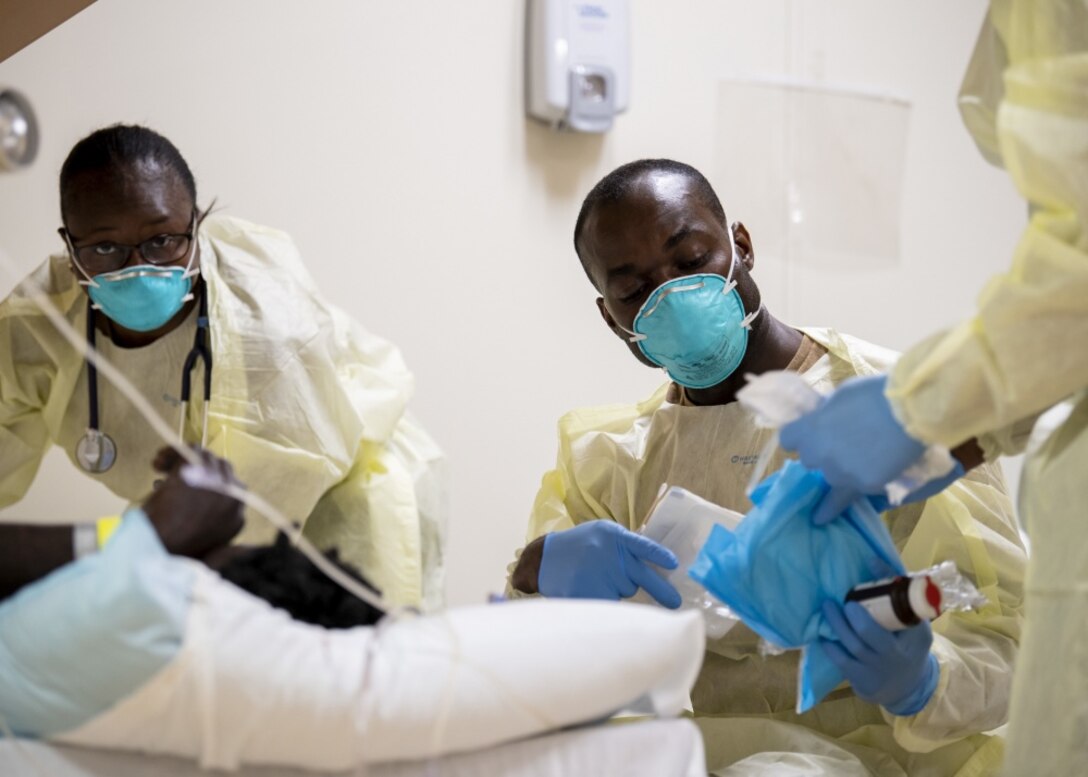 Hospital staff care for a patient.