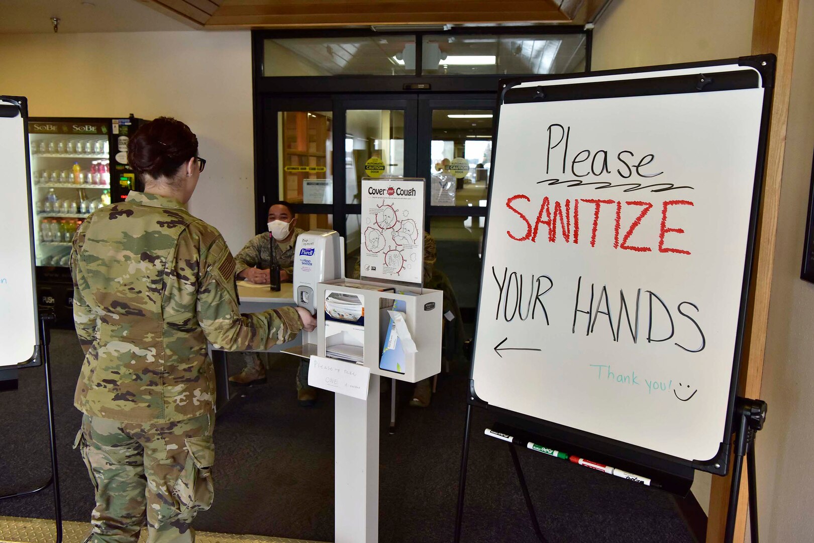 Airman sanitizes hands