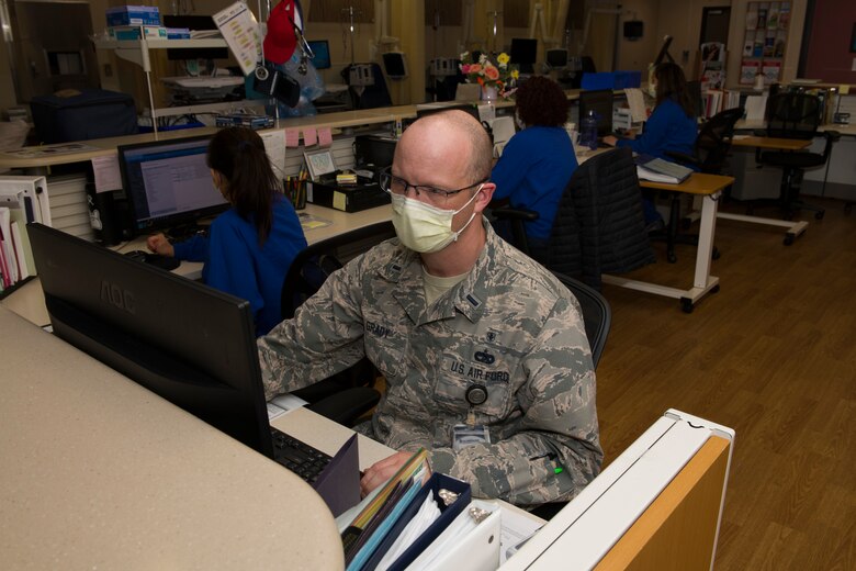 U.S. Air Force 1st Lt. Michael Grady, 60th Medical Operations Squadron nurse manager, reviews a patient's records inside the Hematology and Oncology Clinic March 25, 2020, at David Grant USAF Medical Center at Travis Air Force Base, California. The clinic, which provides a range of treatments for cancer patients, is one of many services the medical center is providing during the COVID-19 pandemic. (U.S. Air Force photo by Tech. Sgt. James Hodgman)